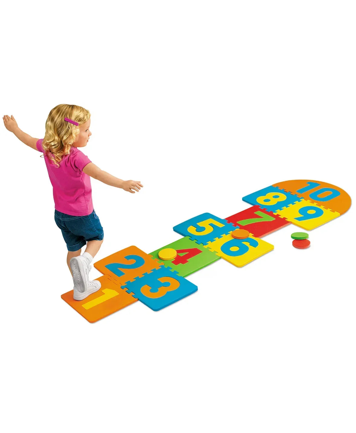Angled view of Lakeshore hopscotch foam mat with colorful tiles numbered 1-10 and child balancing on white background