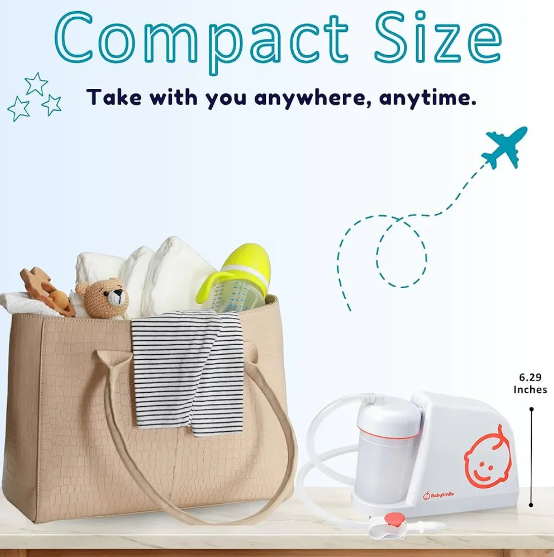 Compact portable baby nasal aspirator next to diaper bag with baby essentials.