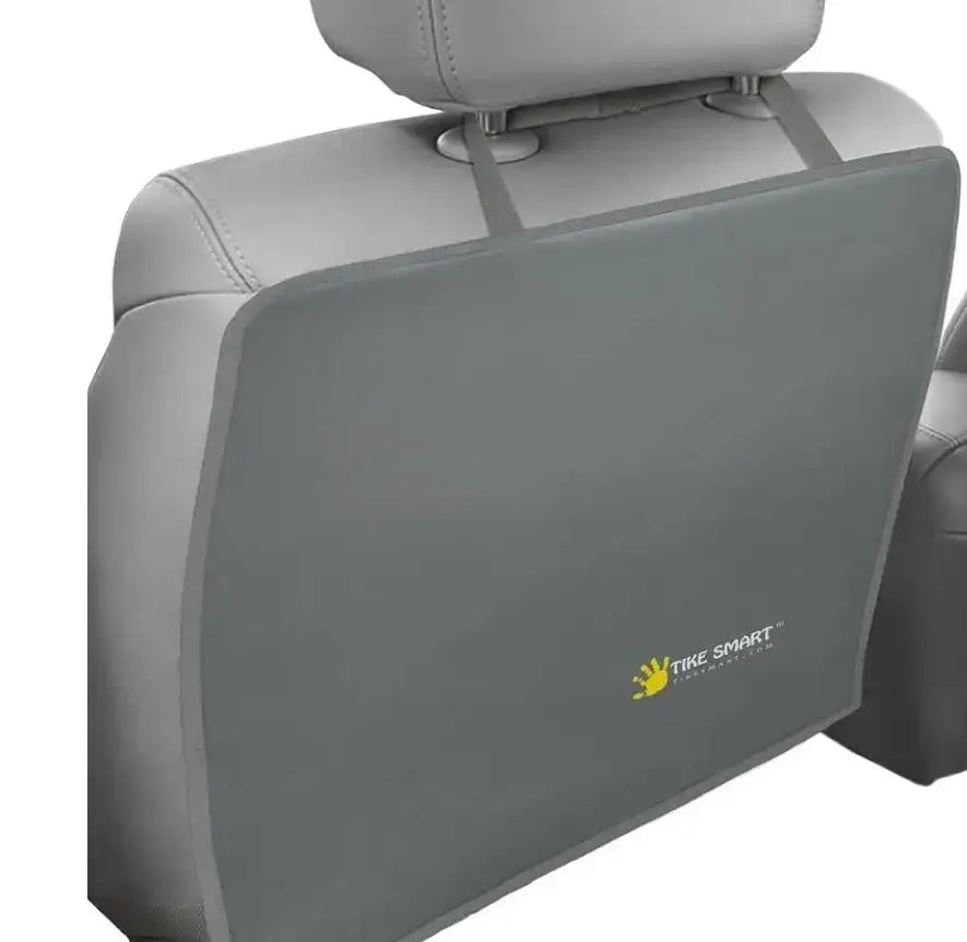 Product shot of NWT Tike Smart Clean-Edge Kick Mat showcasing gray cover with yellow handprint logo strapped to car seat back