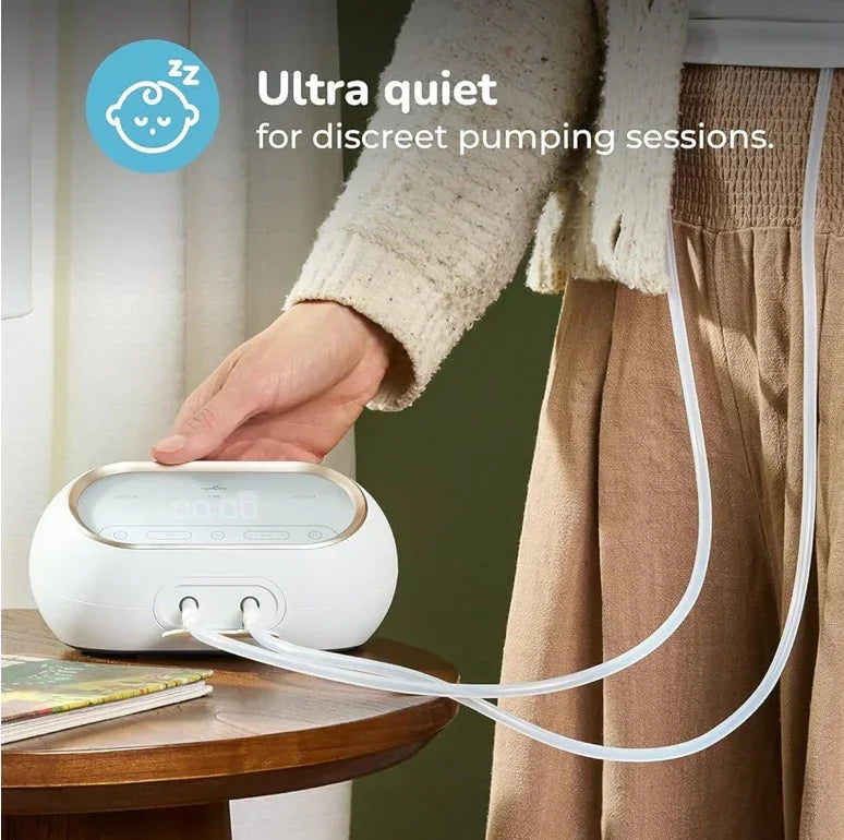 Woman using ultra-quiet electric breast pump for discreet pumping sessions at home.