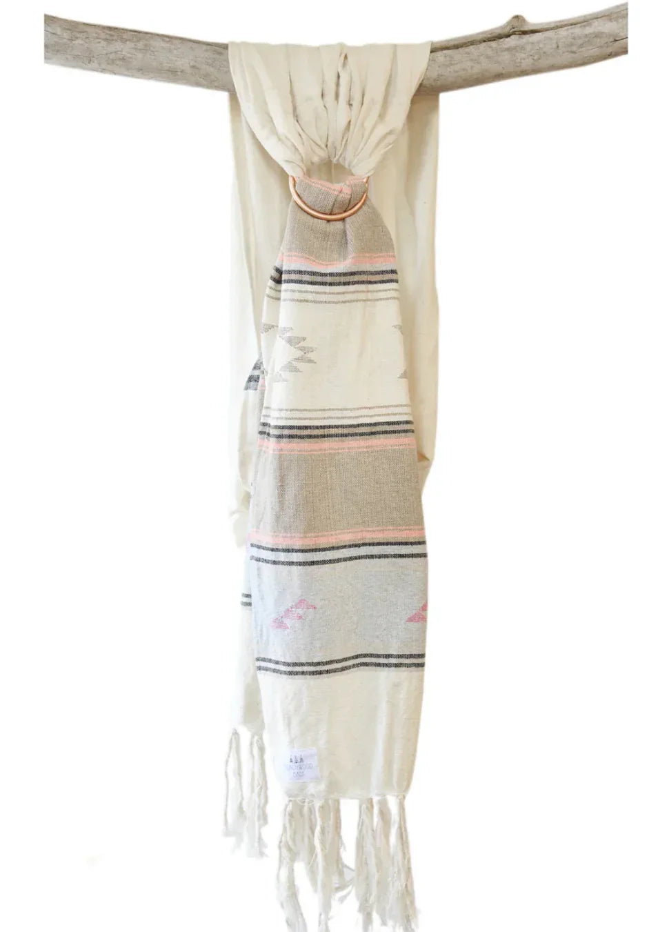 Neutral woven baby ring sling with geometric pattern and tassels hanging on wood branch