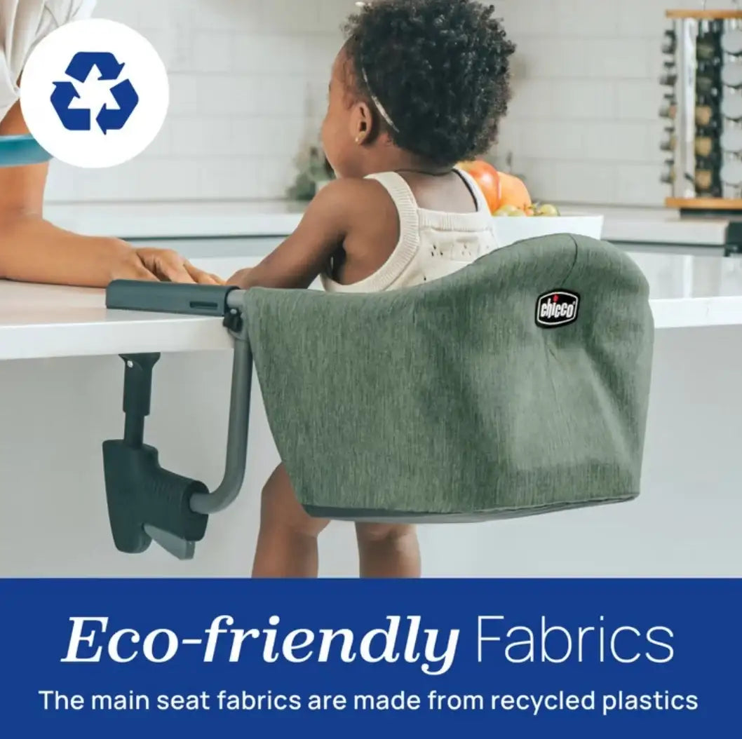 Rear view of Chicco FastLock hook-on high chair in grey showing table attachment and Eco-friendly Fabrics with child seated
