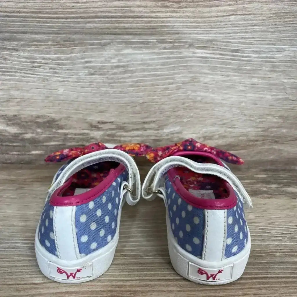 Rear view of Wellie Wishers doll shoes size 5C, purple polka dots, white soles, pink trim and floral bows on wood