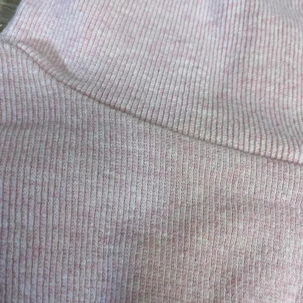 Close-up of Little Bipsy ribbed twirl dress, size 0-3m, showcasing blush pink ribbed knit fabric and seam detail
