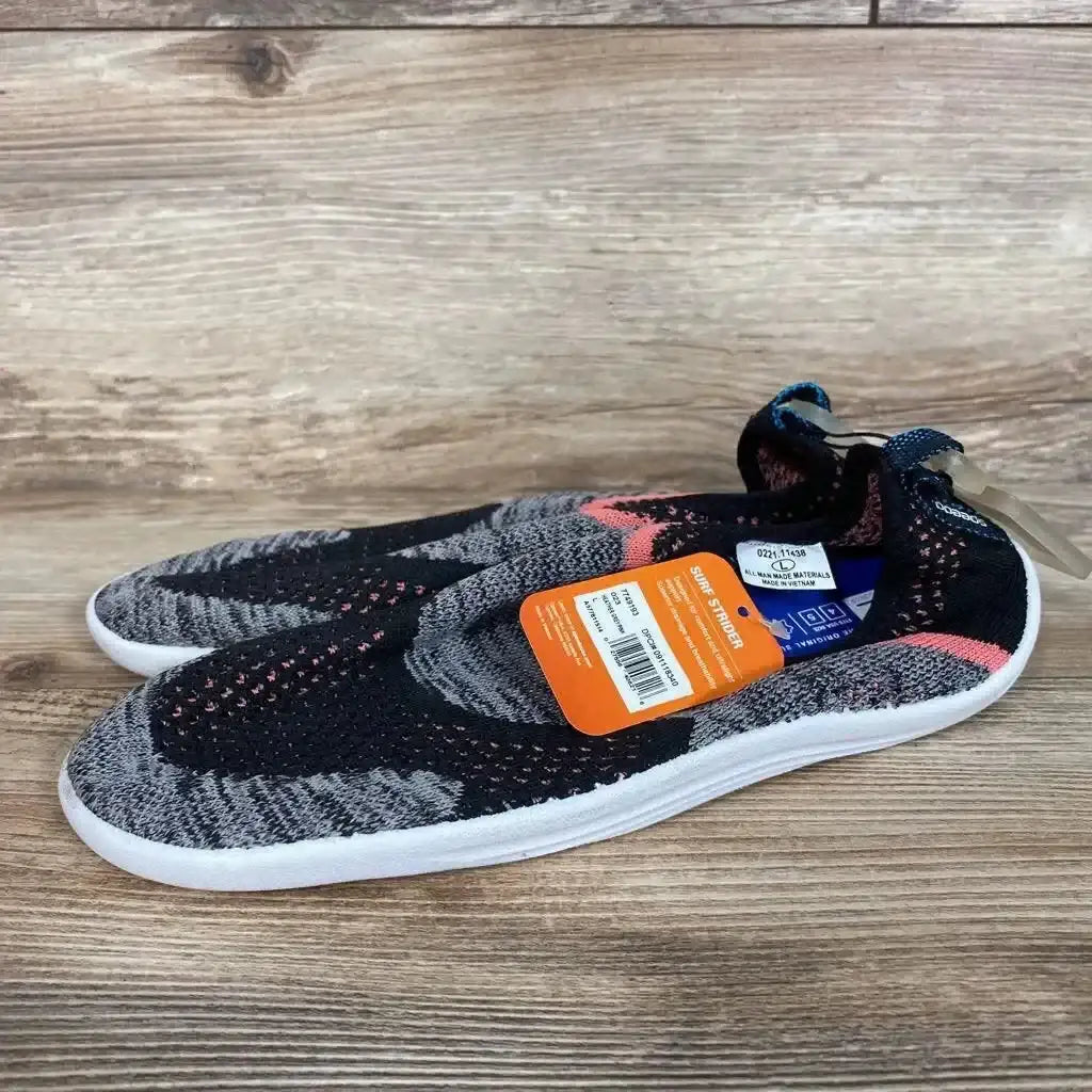 Angled side view of Speedo Junior Surf Strider water shoes, size 4/5Y, showing knit upper and white sole on wood surface