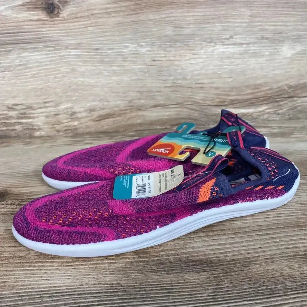 Side view of Speedo Junior Surf Strider water shoes, size 4/5Y, fuchsia knit upper with navy heel and white sole on wood
