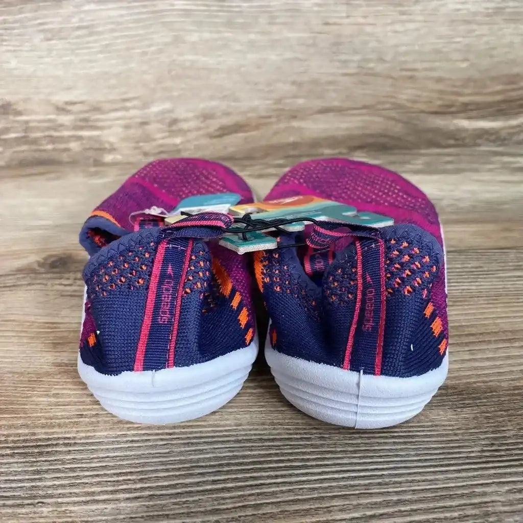 Rear view of Speedo Junior Surf Strider water shoes in fuchsia and navy, showing bungee laces and white soles on wood surface