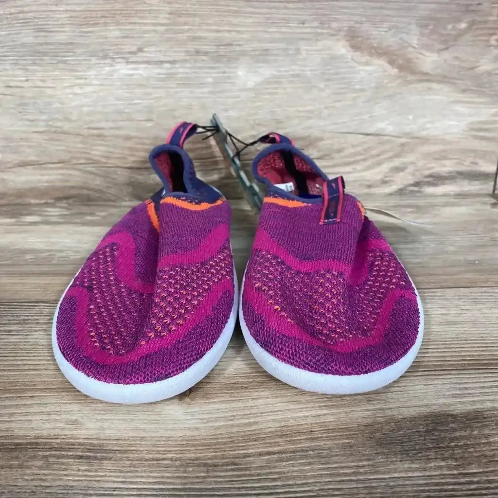 Front view of Speedo Junior Surf Strider water shoes in fuchsia knit with white soles on wooden background