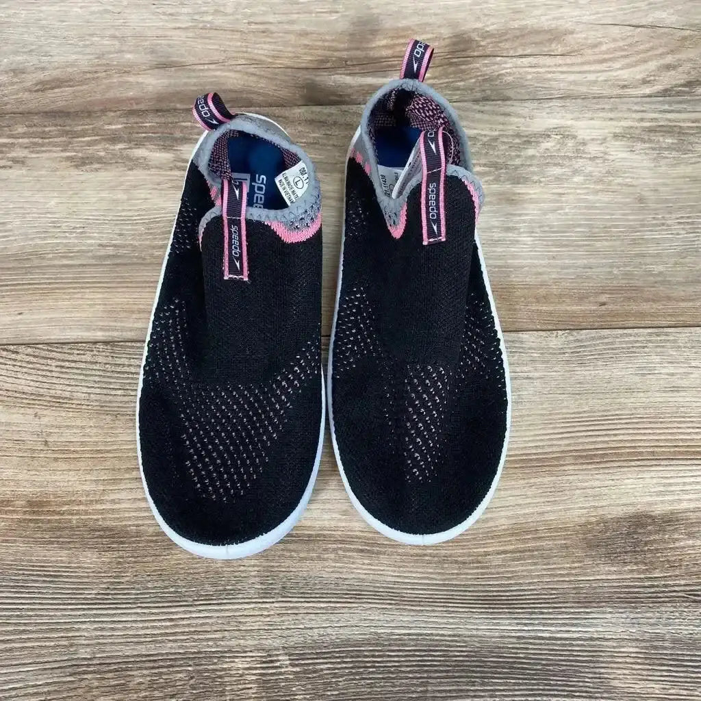 Top view of NEW Speedo Junior Surf Strider water shoes in size 9/10Y showcasing pink accents and white outsoles on wood