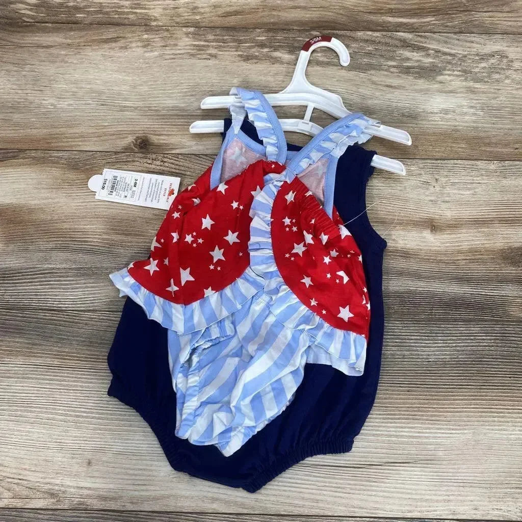 Top view of Cat & Jack 3-piece baby romper set (3–6M) showing navy romper with red star ruffle and blue striped bloomers on wood background