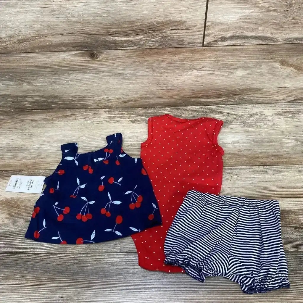 Flat lay of 3-piece baby set (3M): navy cherry-print sleeveless top, red polka-dot bodysuit, navy-white striped bloomers on wood