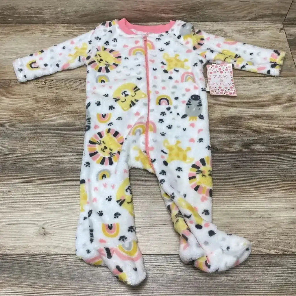 Flat lay of Zak & Zoey white fleece footed sleeper with yellow and pink animal rainbow print and front zipper on wood floor