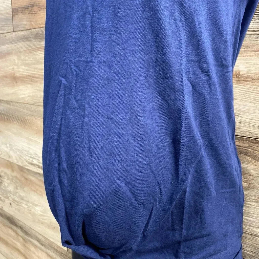 Front view of navy maternity twist-knot t-shirt showing twisted front hem and ruched belly against wood background