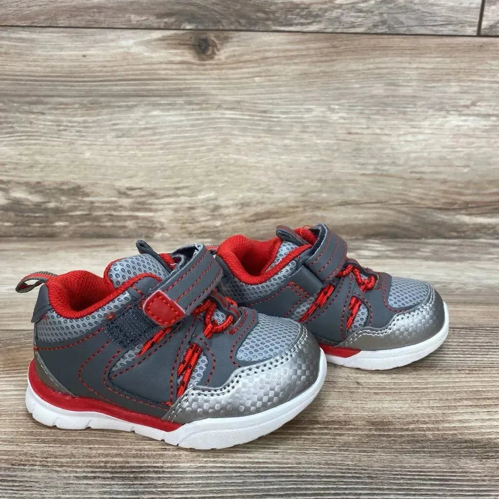 Side view of toddler Athletic Works grey sneakers (size 4C) showing hook and loop strap, red lining, mesh upper on wood floor