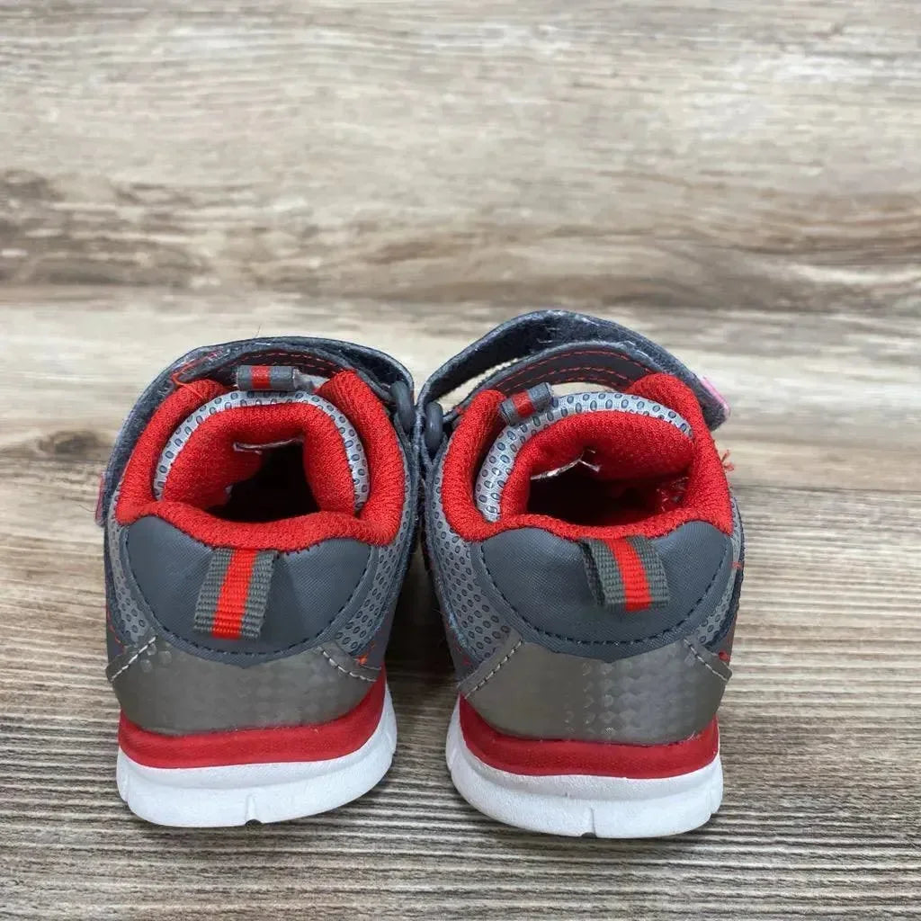 Rear view of used grey and red toddler Athletic Works sneakers size 4C showing padded red lining on wood floor