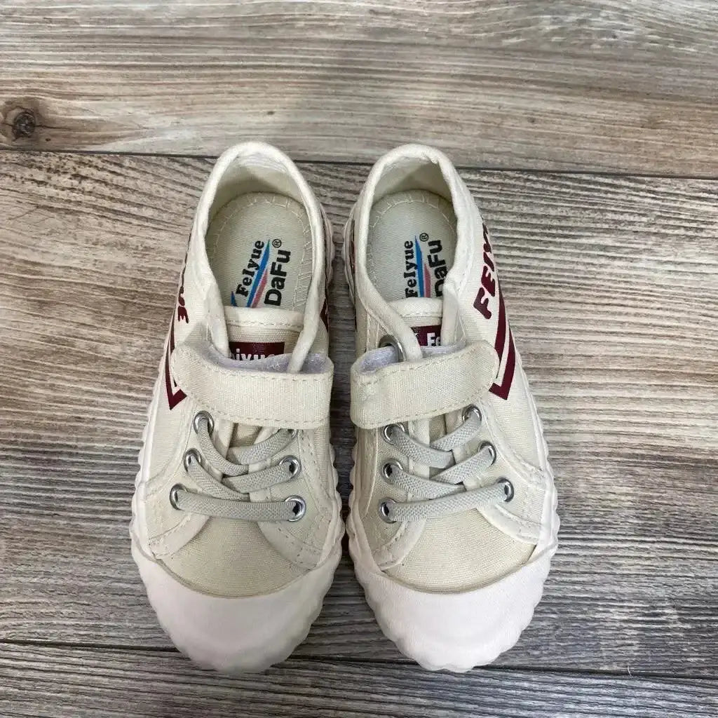 Top-down view of tan Feiyue Fe Lo 1920 toddler shoes showing Velcro strap, laces and red side logo on wood floor