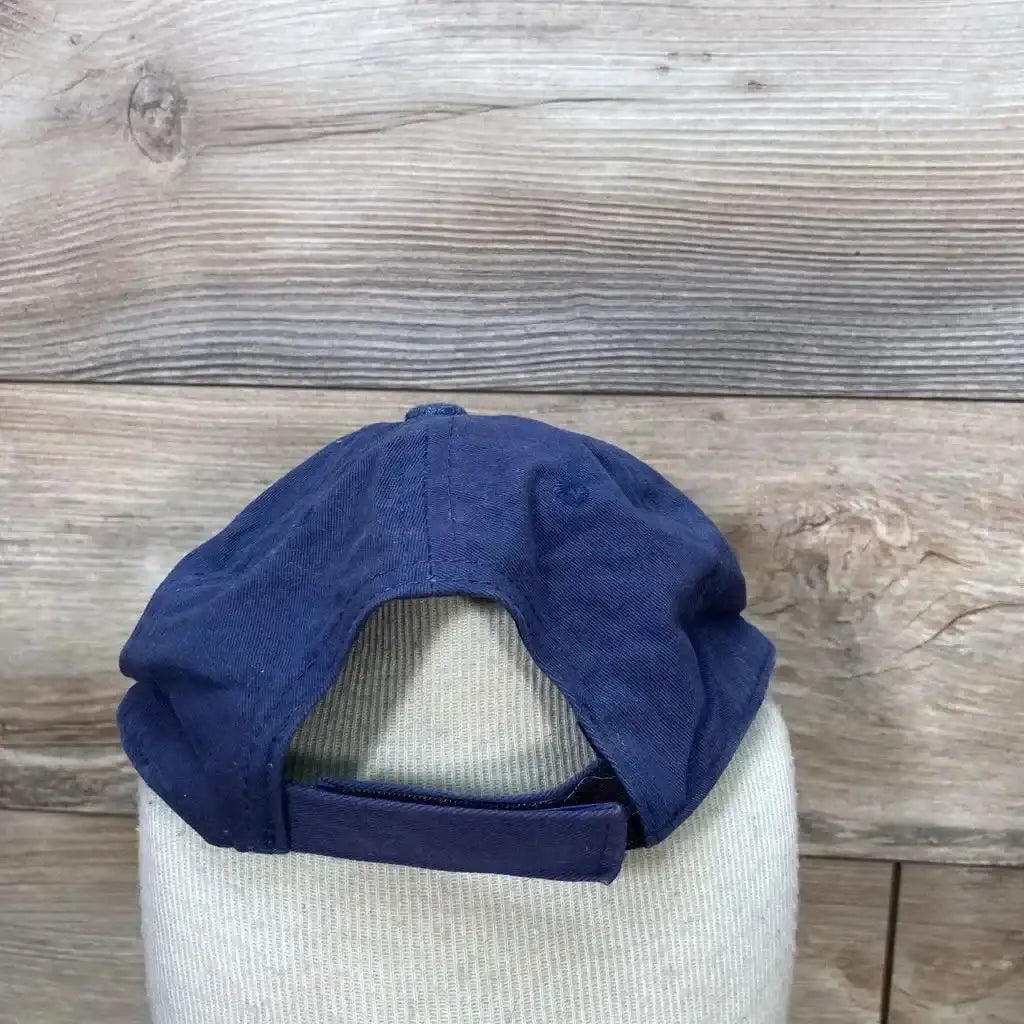 Rear view of used blue toddler baseball cap for 6 to 24 months showing adjustable Velcro strap and back opening on a wooden background