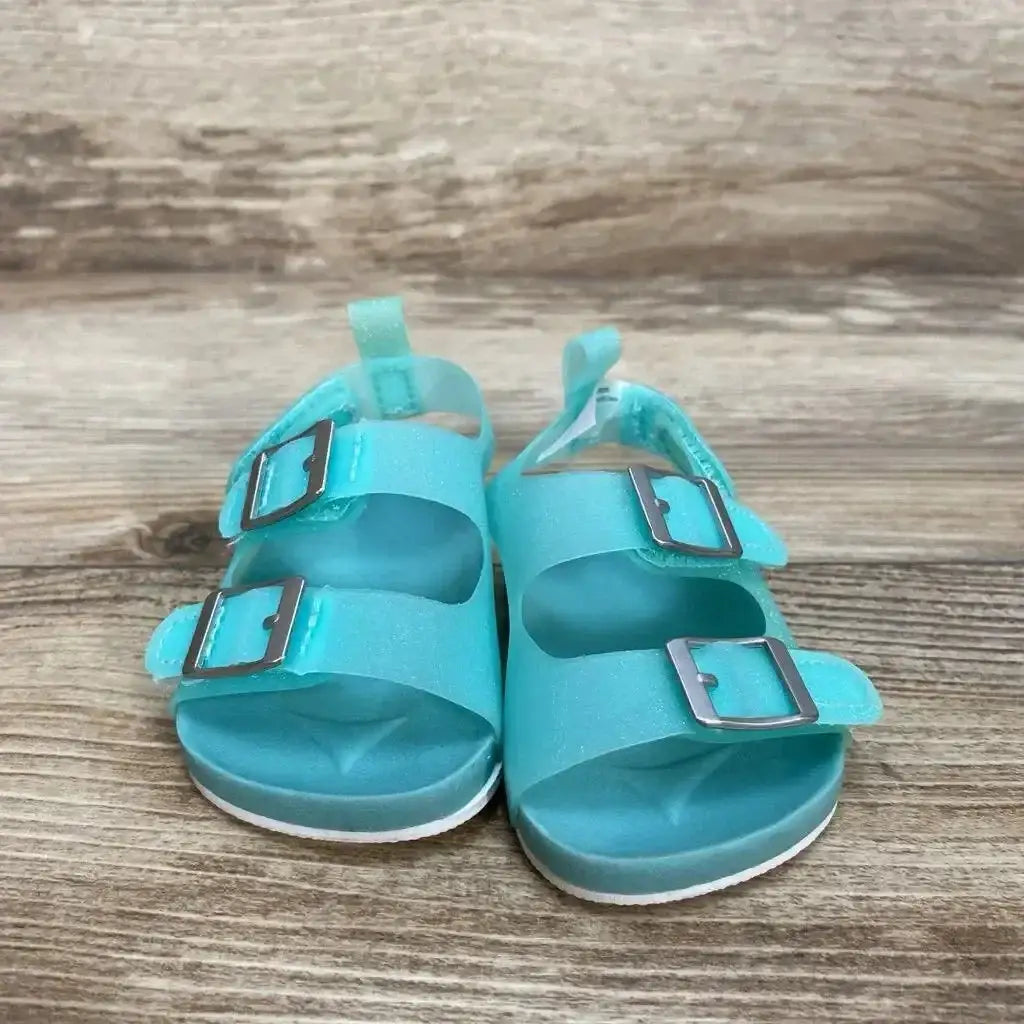 Side view of teal newborn Carter’s jelly sandals showing buckle strap and textured sole on white background