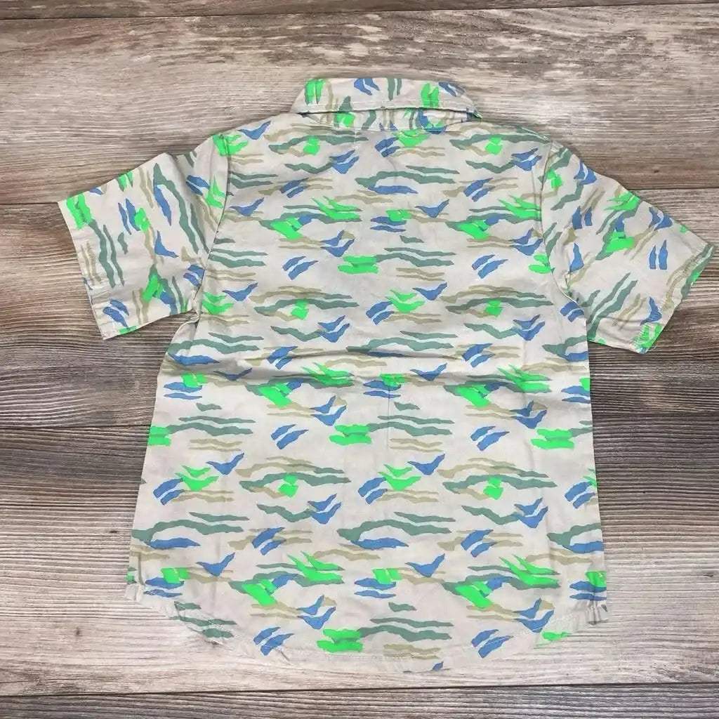 Back view of NEW Miki Miette Button Front Shirt in beige with green blue and olive abstract camo print on wood plank floor