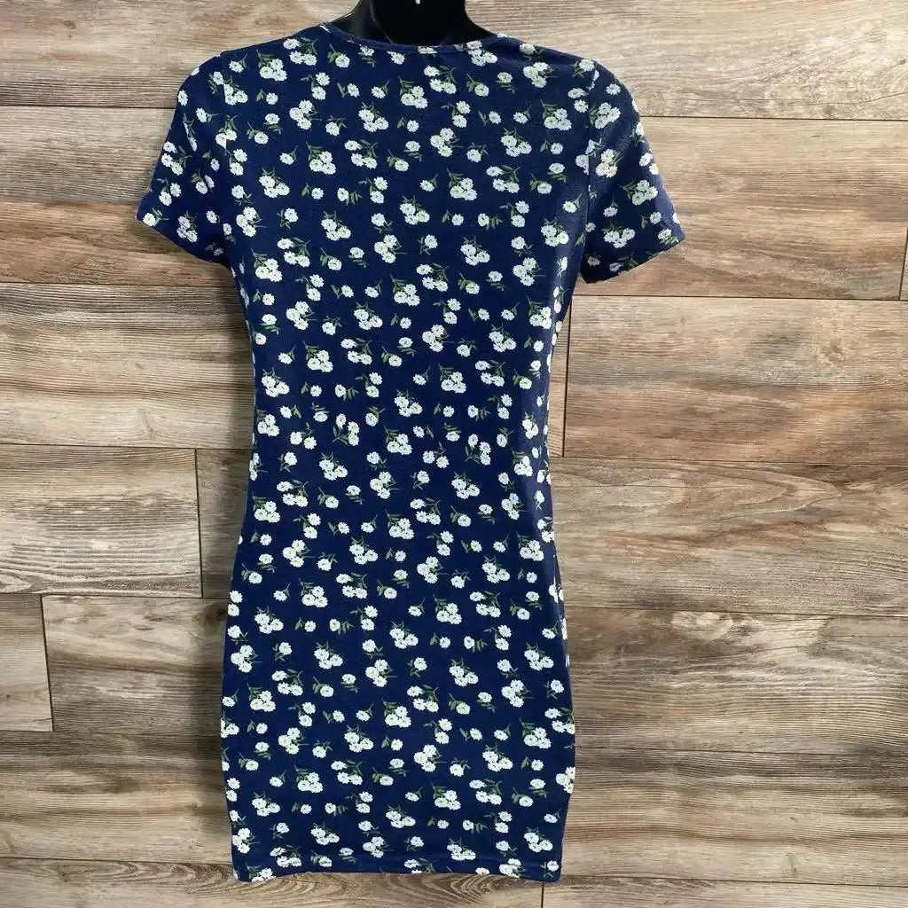 Front view of navy floral maternity bodycon dress on mannequin showing short sleeves and fitted silhouette on wood background