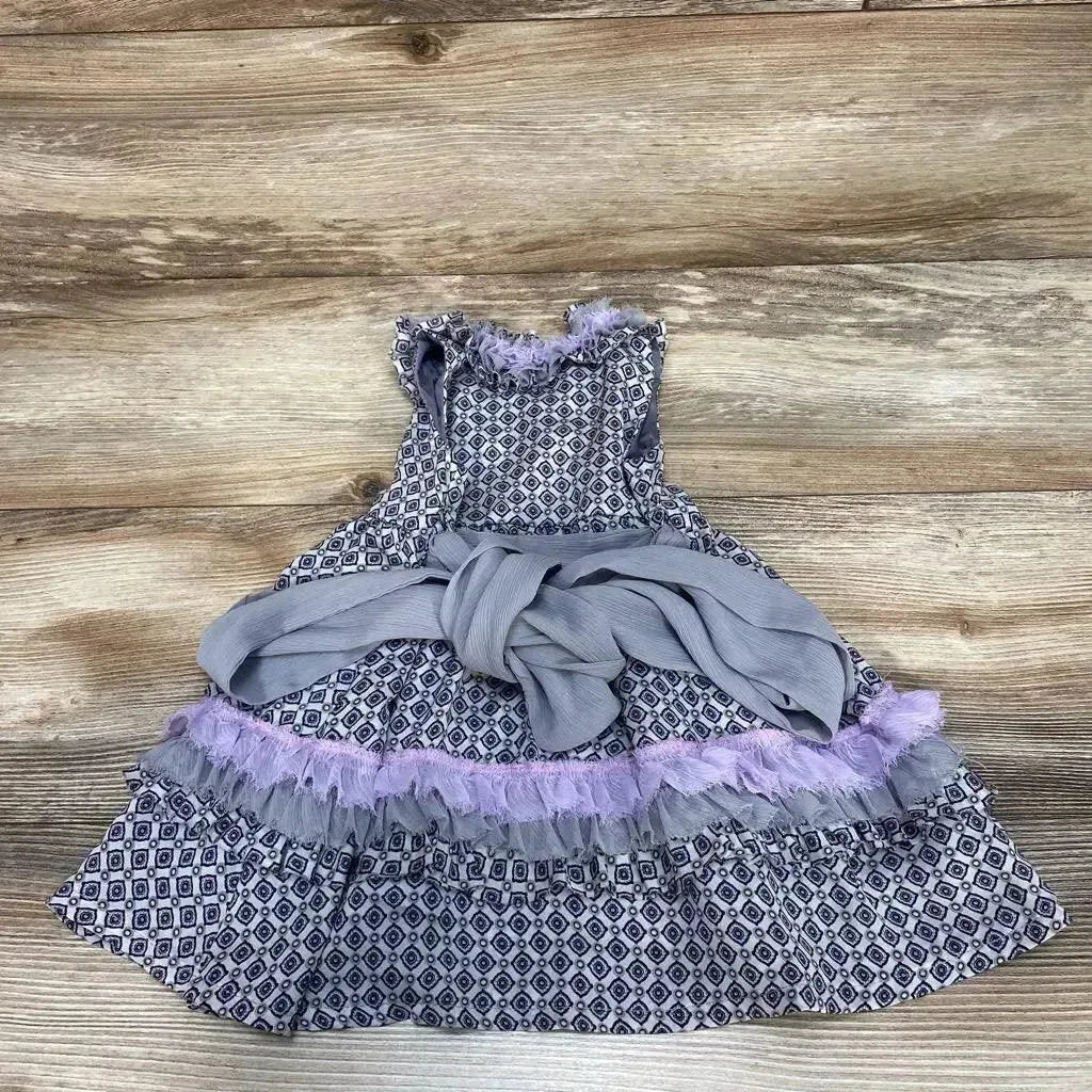 Top-down view of Trish Scully ruffle dress size 6m showcasing purple tulle ruffle trim and tied sash on wood background