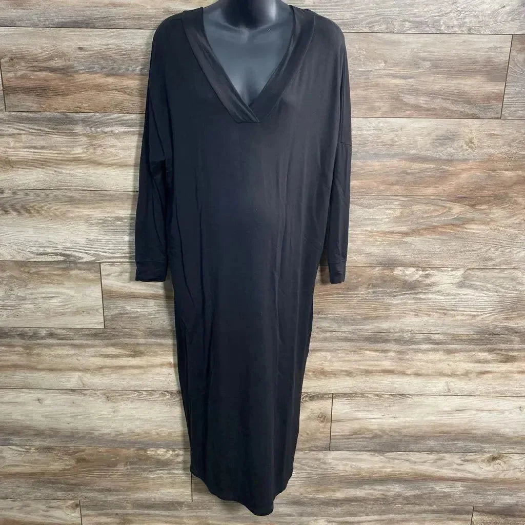 Front view of black Quince maxi dress on mannequin showing V-neck, long sleeves, relaxed ankle-length fit on wood background