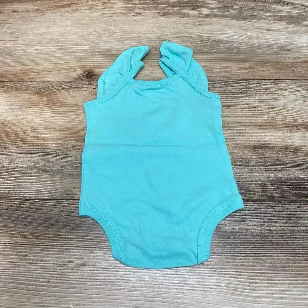 Flat lay of aqua newborn tank bodysuit showcasing ruffle shoulder straps and snap bottom on wood background