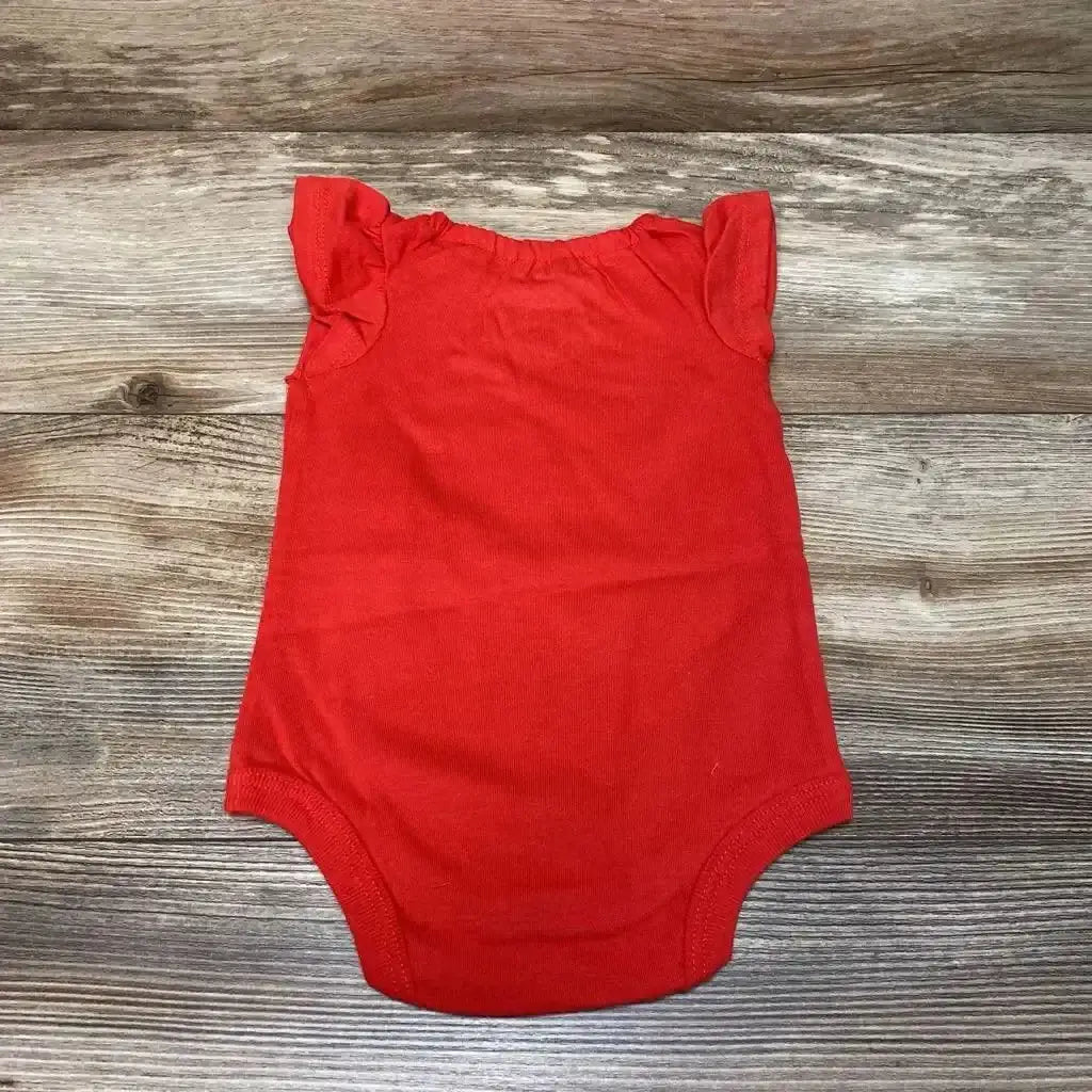 Flat lay of red Okie Dokie Happy Baby Club bodysuit, 3 months, showing ruffle cap sleeves and snap crotch on wood background