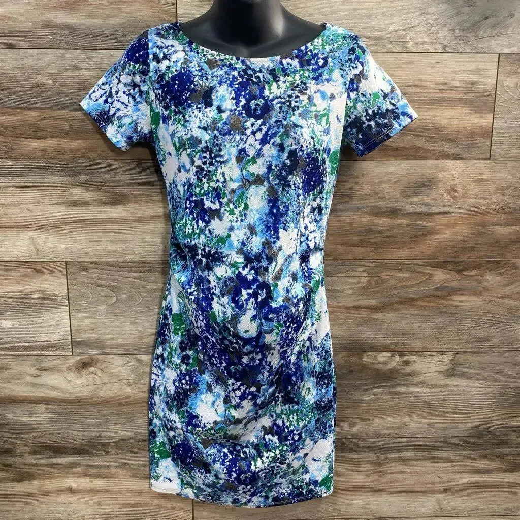 Front view of small maternity bodycon dress with blue-green floral print, short sleeves, fitted on black mannequin against wood background