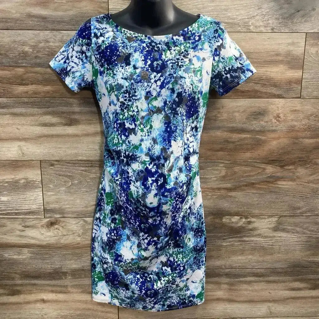 Front view of Pink Blush Maternity Floral Bodycon Dress size Small showcasing blue green and white floral print short sleeves and ruched sides on a dress form against wood plank wall