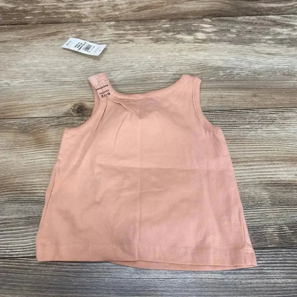 Back view of Baby Gap pink tank top (6-12m) laid flat showing ribbed armholes and shoulder size tag on wood background