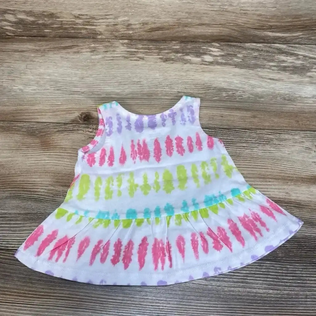 Flat lay of Okie Dokie baby tank top (3 months) showing pastel tie-dye stripes and peplum hem on wood background