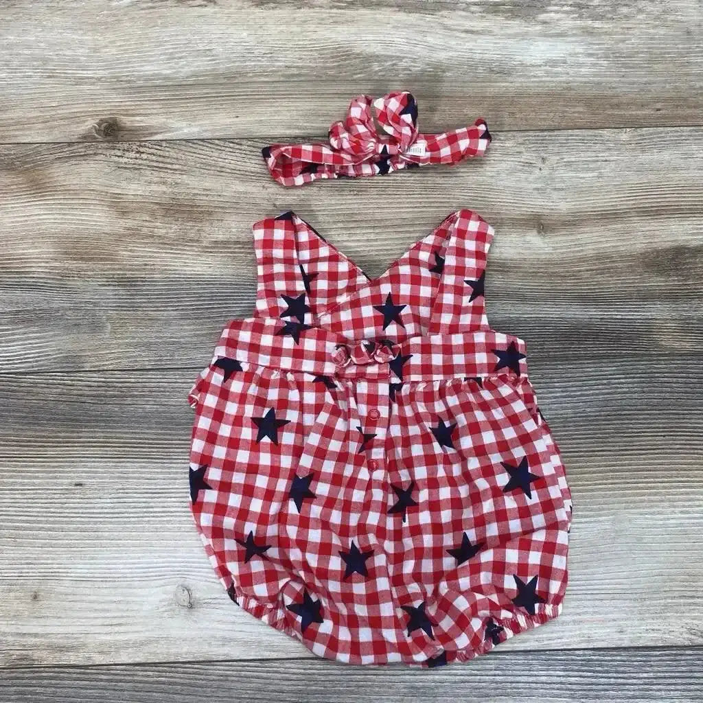Flat lay of Cat and Jack 2pc Gingham Stars Romper and Headband sz 3-6m showcasing red and white check with navy star print on wood plank background