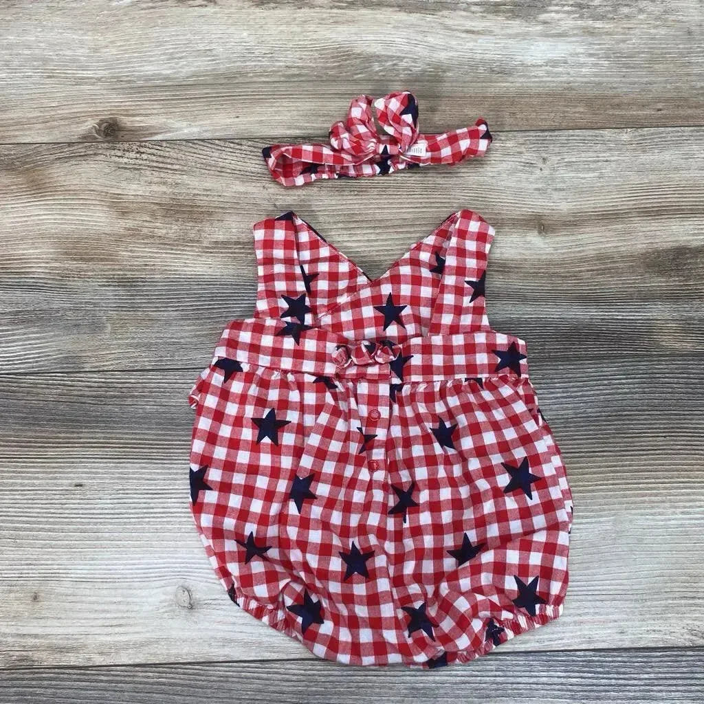 Flat lay of red and white gingham baby romper with navy stars and matching headband, size 3-6 months, on wood background