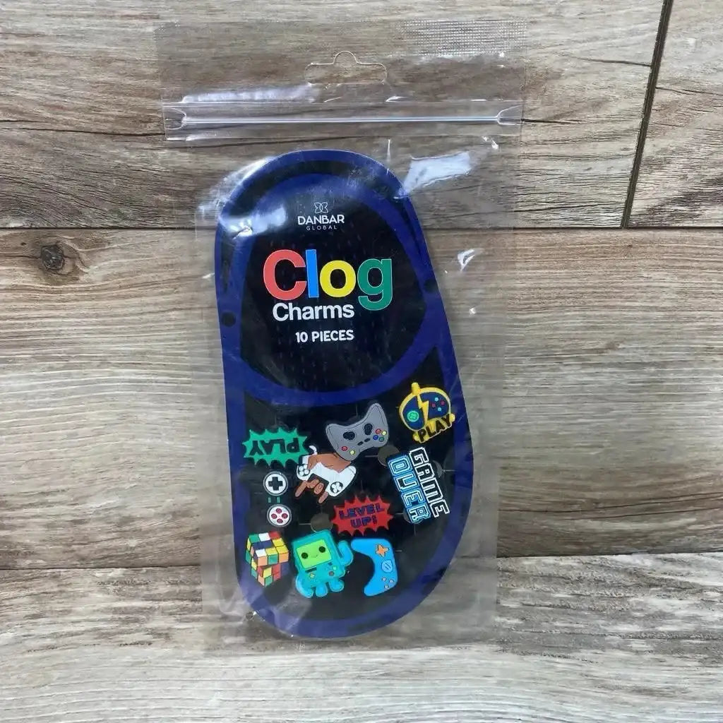 Front view of NEW Danbar Global 10pc Clog Charms Jibbitz with gamer themed designs in original sealed packaging on wood floor