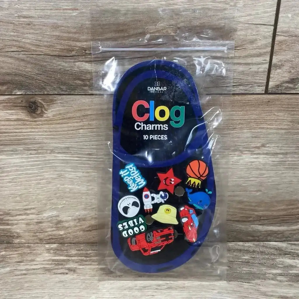 Front of Danbar Global 10pc clog charms pack showing assorted charms and visible packaging text Clog Charms on wood background
