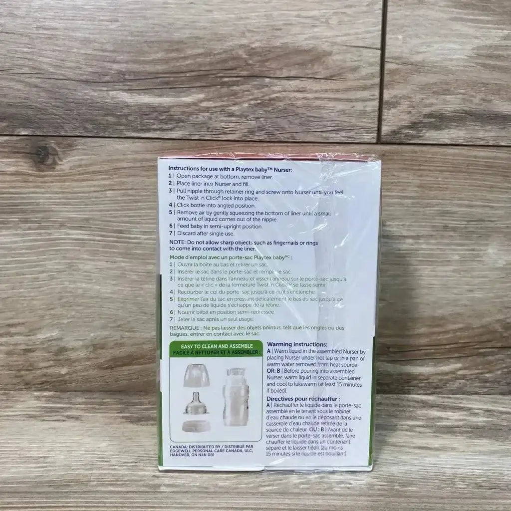 Rear view of Playtex Baby Nurser Drop-Ins Liners 100 ct box showcasing printed usage instructions and product illustrations on wood background
