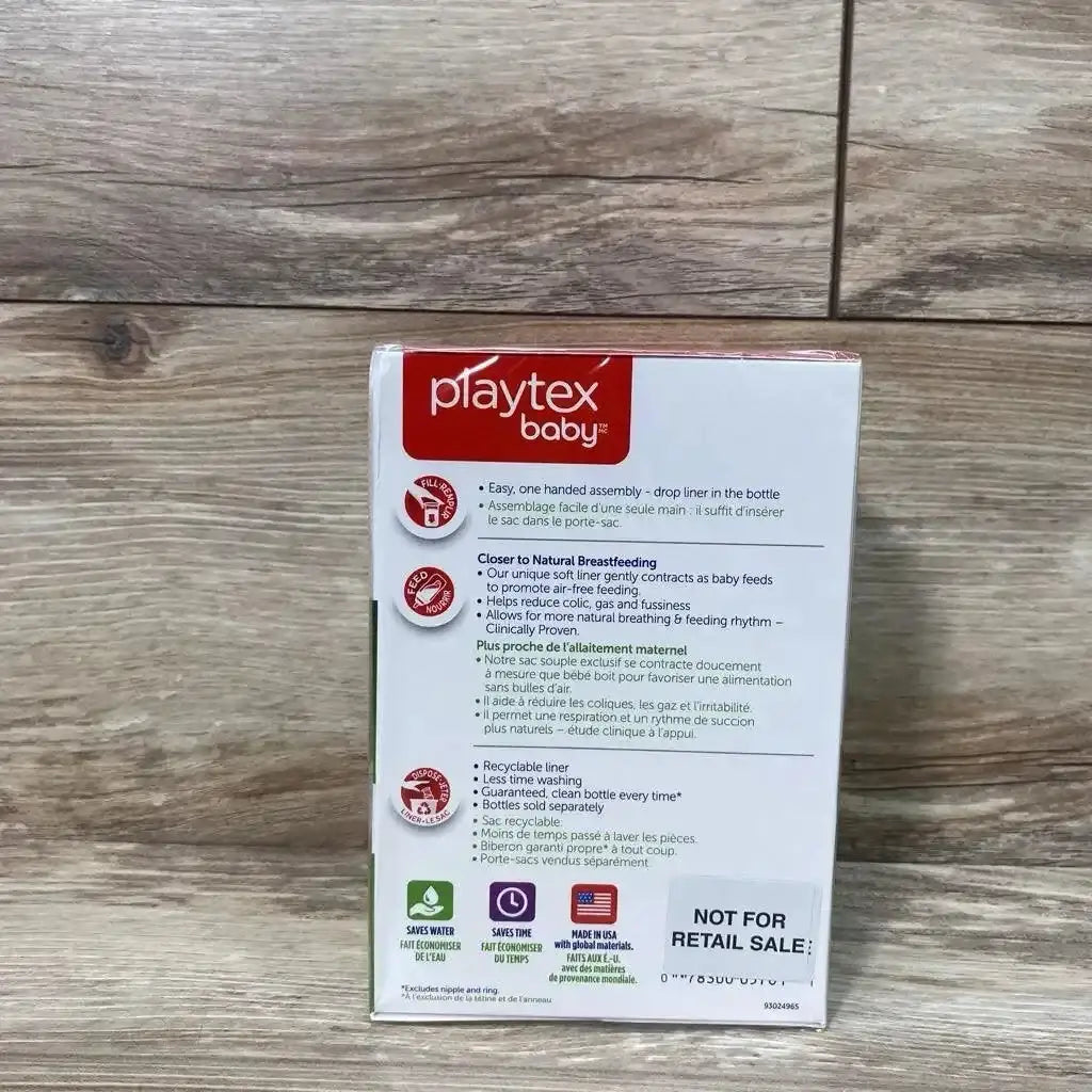 Back view of Playtex Baby Nurser Drop Ins Liners box showcasing Not For Retail Sale label and product feature list on wood plank floor