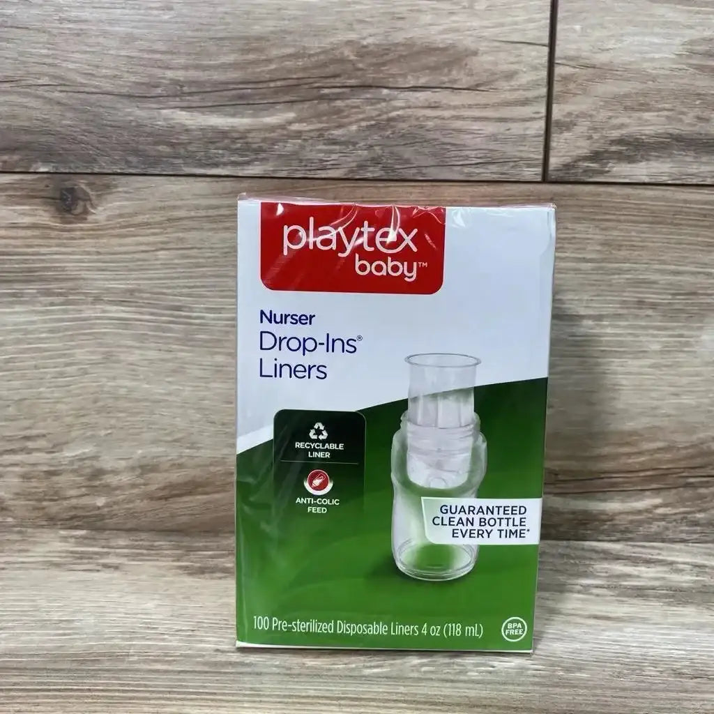 Front view of Playtex Nurser Drop-Ins 100-count box showing 4 oz liners and recyclable, anti-colic callouts on wood table