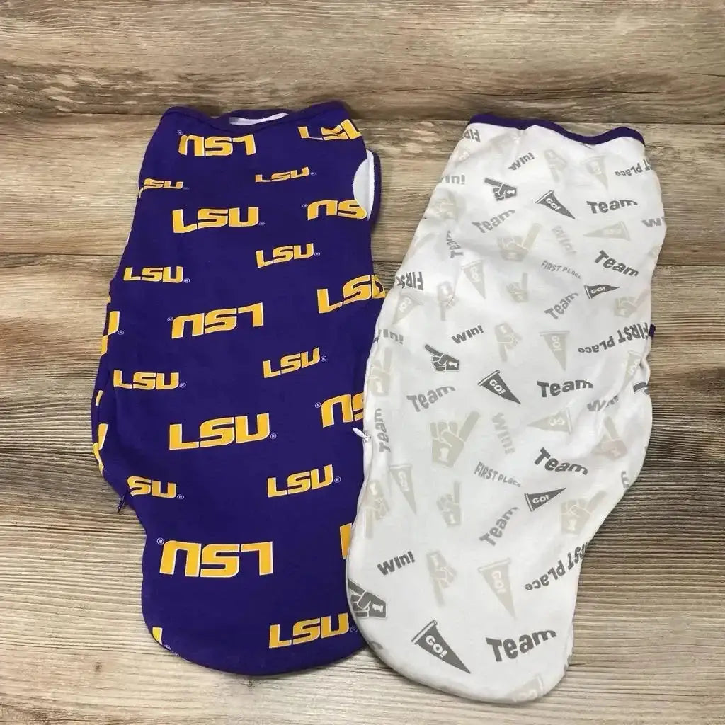 Top-down view of two 0-3m swaddle wraps, one purple with LSU print and one white with gray team-print on wood background