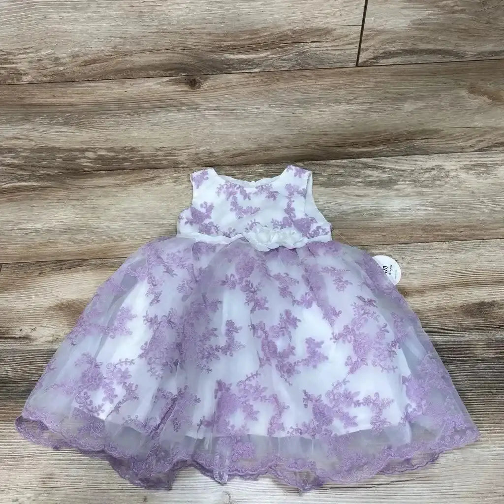 Flat lay of white 2T toddler dress with lavender floral embroidery and tulle skirt on wood floor