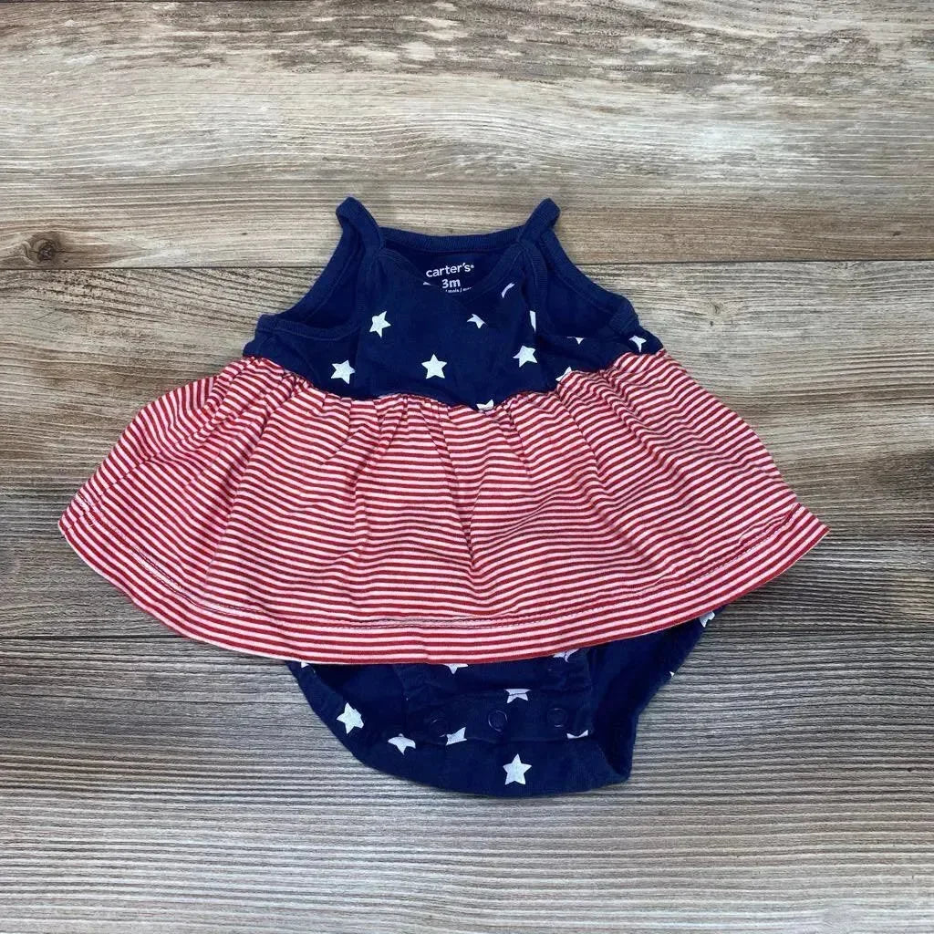 Flat-lay of Carter's size 3M navy sleeveless bodysuit dress with white stars and red-striped skirt on wood background