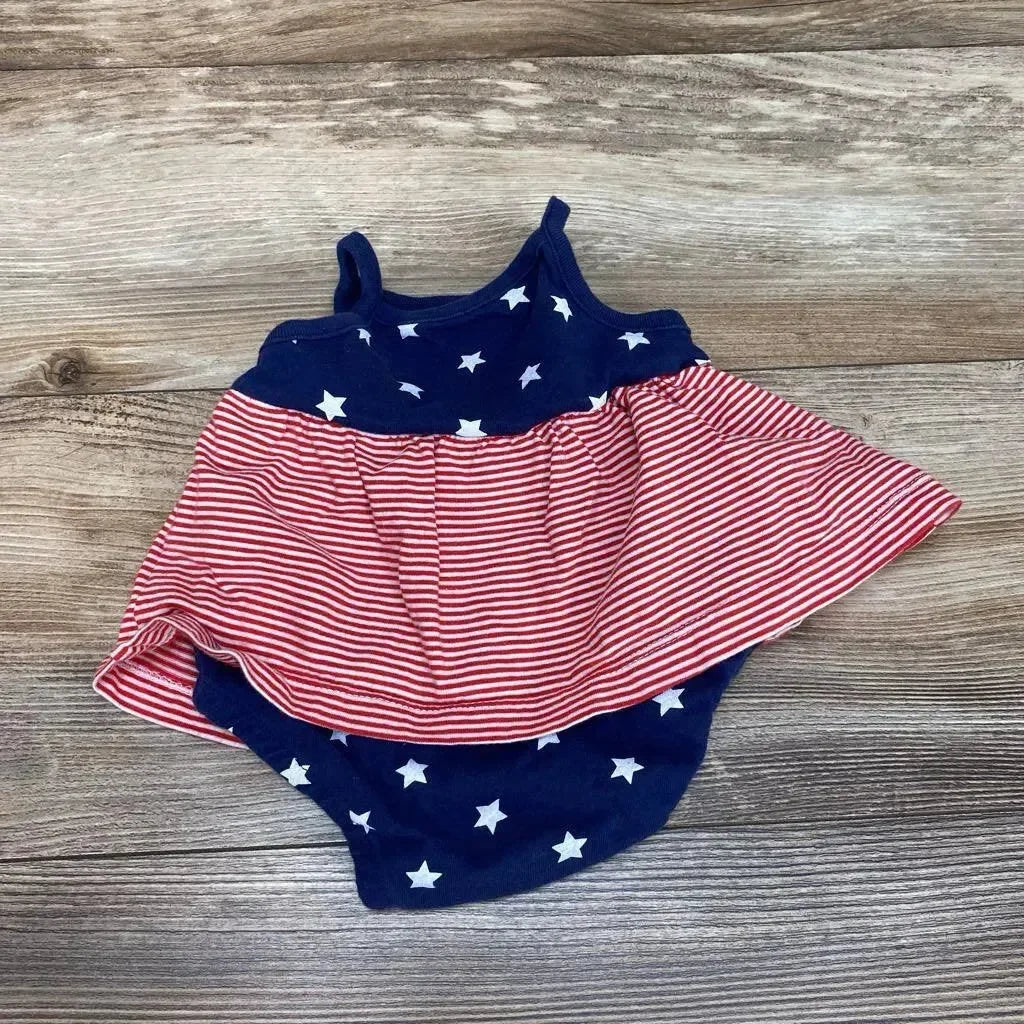Top view of navy star print bodysuit dress size 3M showing red and white striped skirt on wood background