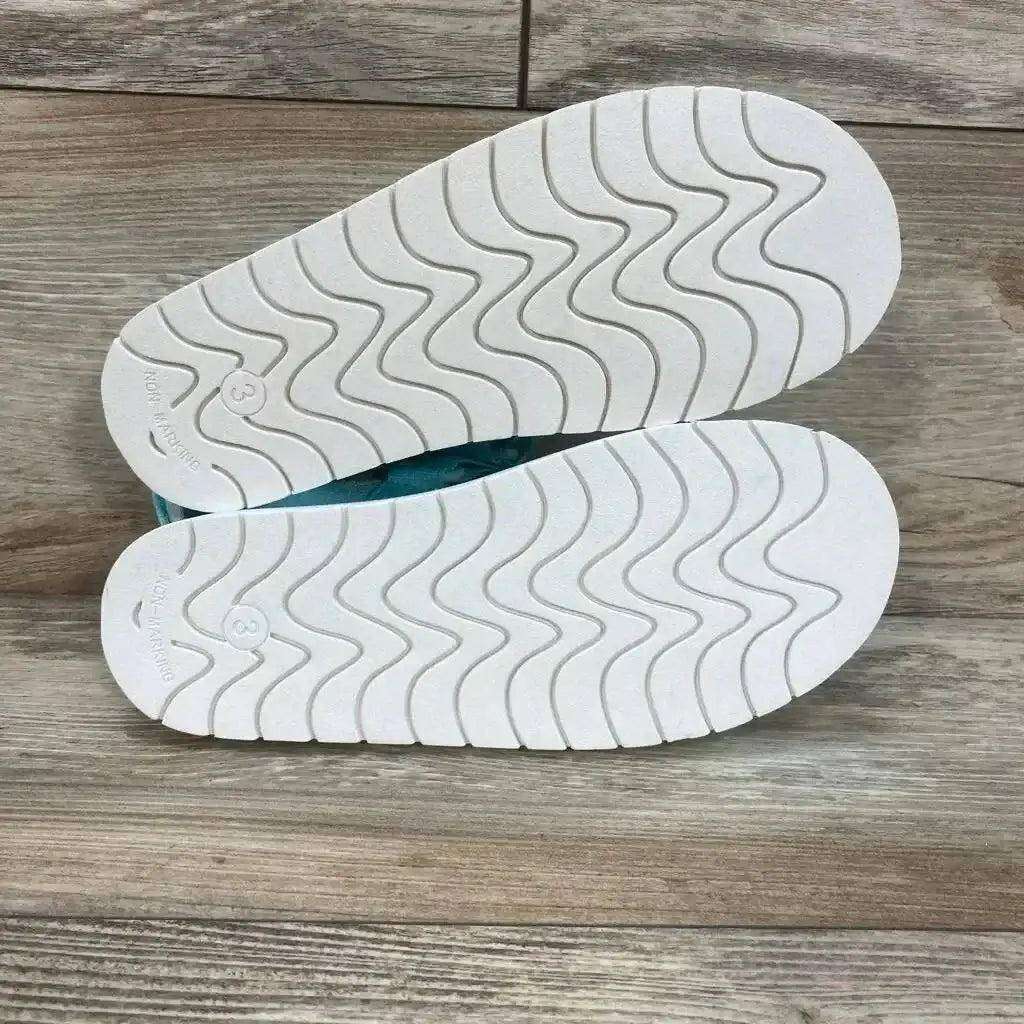 Bottom view of Cat & Jack Emery ankle-strap sandals, turquoise size 3Y, showing white wavy non-marking soles on wood background