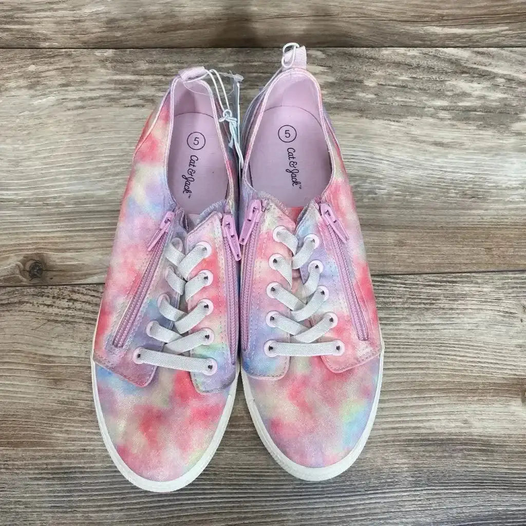 Top-down view of Cat and Jack Lucian double-zipper sneakers, size 5, pastel pink tie-dye with white laces on wooden floor