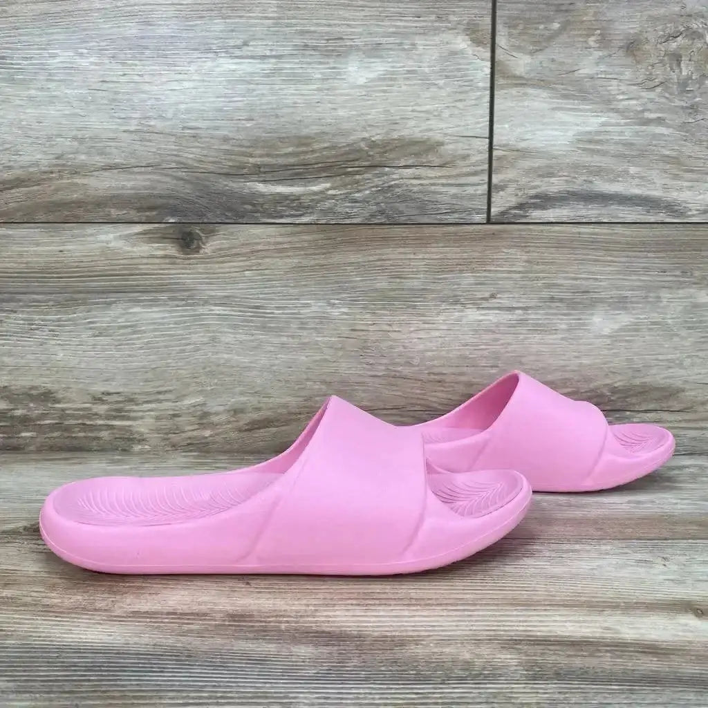Side view of pink All in Motion Apollo slip-on slide sandals showing contoured footbed on wood floor