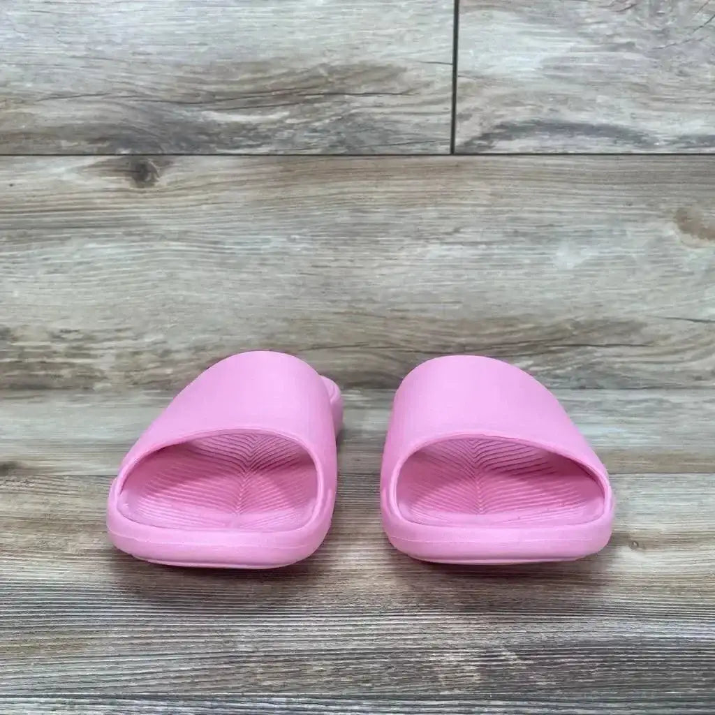 Front of pink All in Motion Apollo slip-on slide sandals, kids size 5Y, textured footbed and wide strap on wood floor