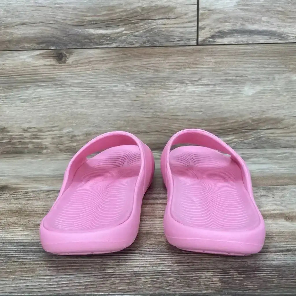 Back view of pink All in Motion Apollo slip-on slide sandals sz 5Y showcasing molded footbed straps on wood plank floor