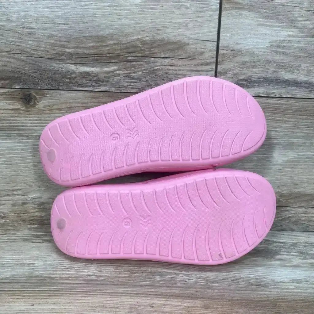 Sole view of All in Motion Apollo Slip-On Slide Sandals in pink showing treaded outsole with size 5 marking on wood plank floor