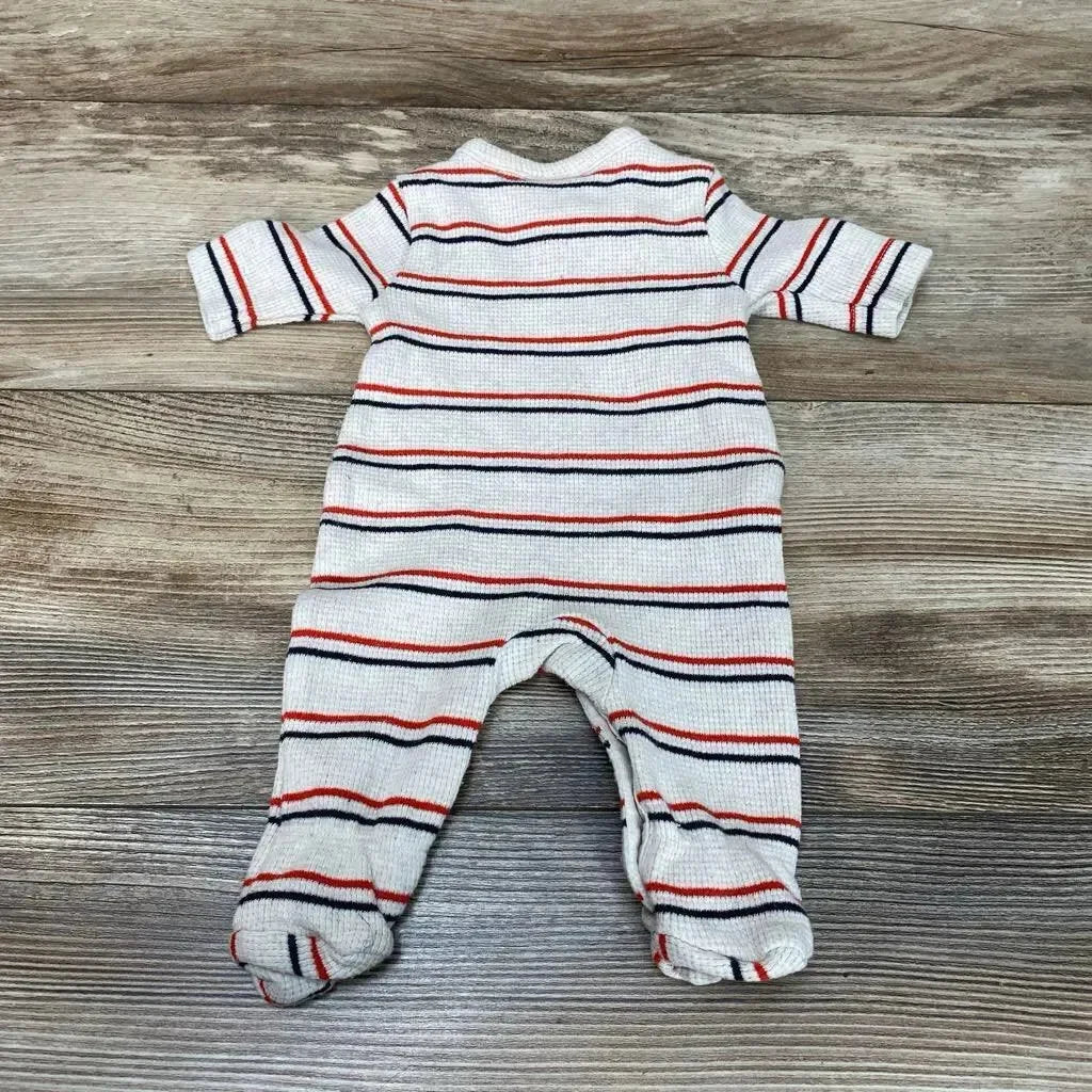 Flat-lay back view of oatmeal preemie sleeper with red and navy stripes and built-in footies on wood background